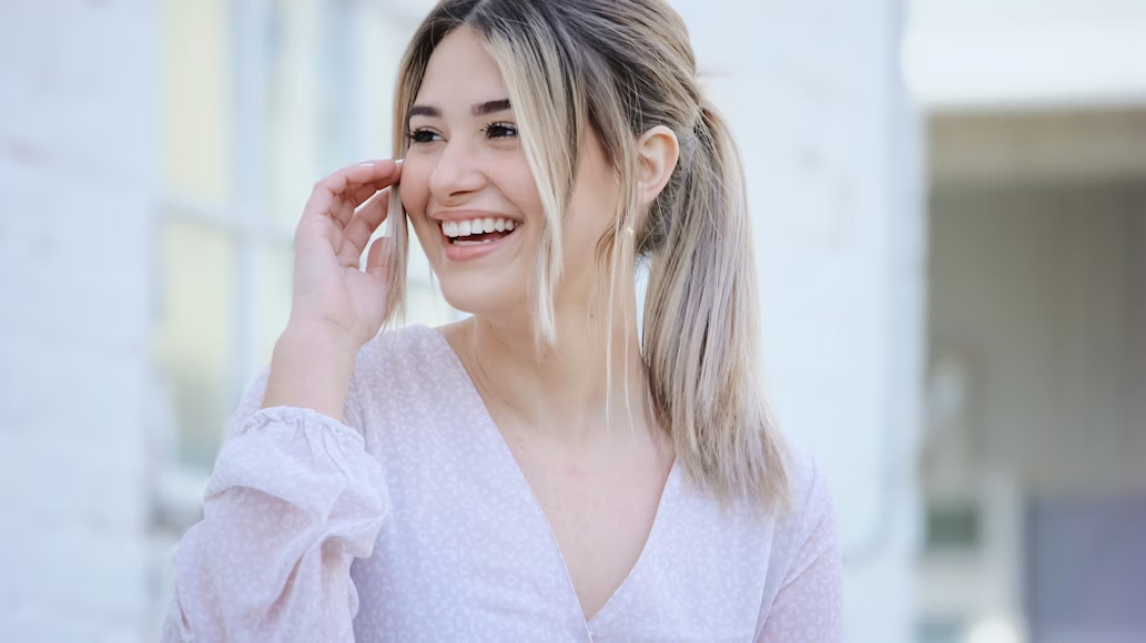 A happy young woman in a white shirt